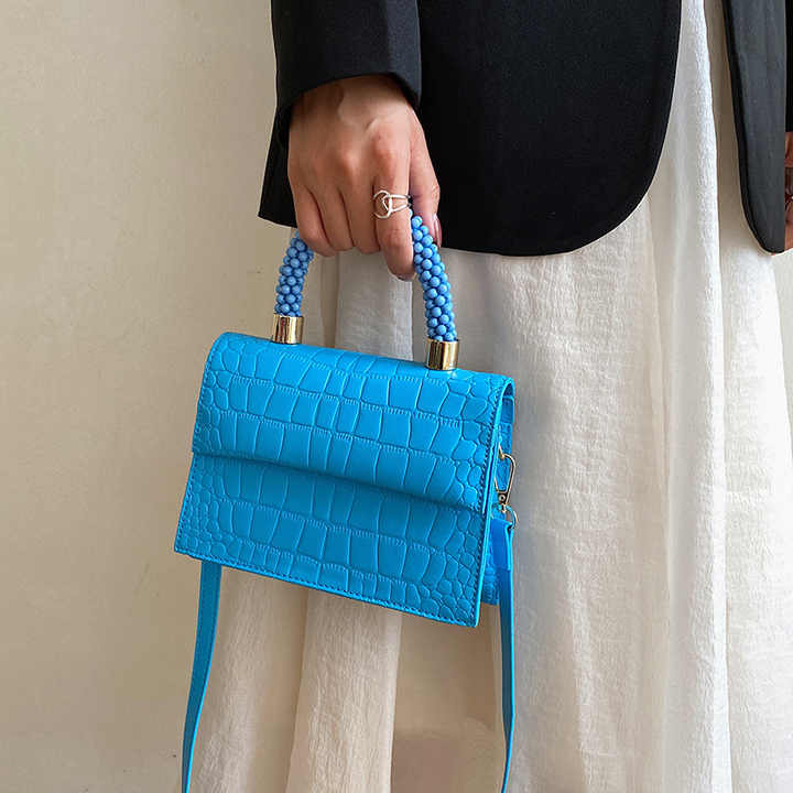 Beaded handle textured bag